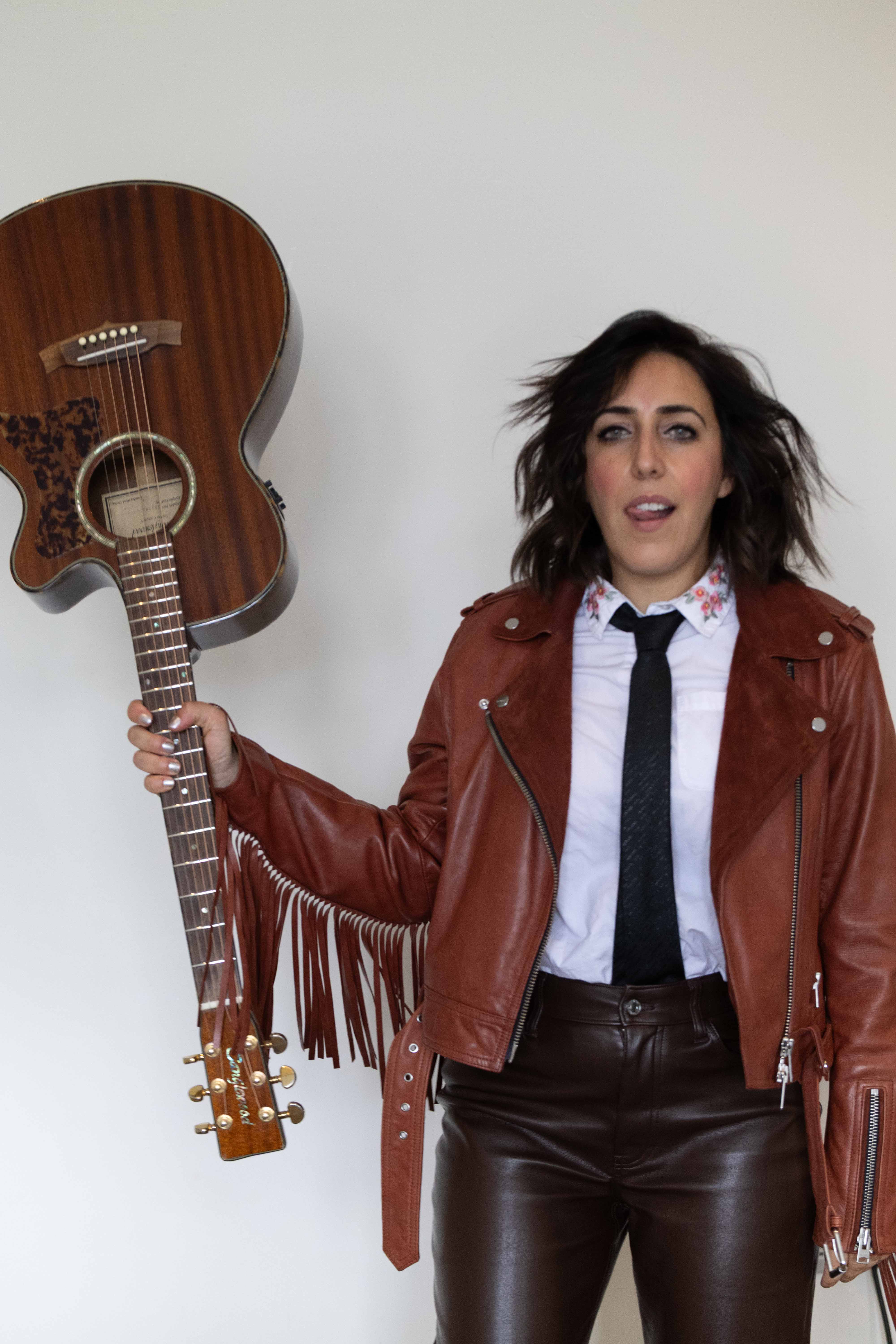 Miranda Arieh holding a guitar